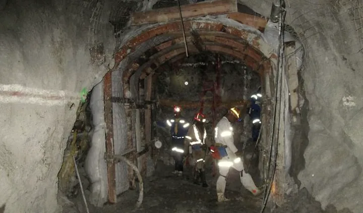 Hlwella underground crew in PPE working at a supported mine face